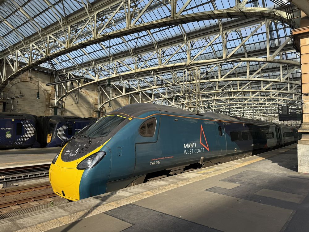Avanti West Coast Pendolino 390047 under a glass station roof.